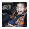 A toddler seats in a car seat.
