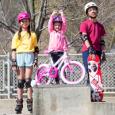 kids on a bike, skateboard, and skates stand triumphant 